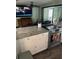 Modern kitchen featuring granite countertops, stainless steel appliances, and ample cabinet space for storage and meal preparation at 3612 Devonshire Dr, Holiday, FL 34691