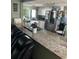 Well-equipped kitchen featuring granite countertops, modern appliances, and ample space for cooking and entertaining guests at 3612 Devonshire Dr, Holiday, FL 34691