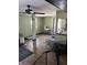 Open-concept living room with hardwood floors, ceiling fan and neutral-toned walls, great for entertaining and relaxation at 3612 Devonshire Dr, Holiday, FL 34691