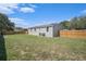 Spacious backyard featuring a well-maintained lawn and a sturdy wooden fence, perfect for outdoor activities at 3924 Kiah Dr, Wesley Chapel, FL 33543