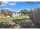 Backyard featuring a deck and a tall wooden fence, providing ample outdoor space and privacy at 3924 Kiah Dr, Wesley Chapel, FL 33543