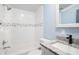 Bathroom featuring white tiled walls, a granite-topped vanity, and a shower/tub combo at 3924 Kiah Dr, Wesley Chapel, FL 33543