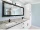 Bathroom featuring a double sink vanity with granite countertop and black hardware at 3924 Kiah Dr, Wesley Chapel, FL 33543