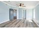 Bright bedroom features light blue walls, a ceiling fan, and light wood-look flooring at 3924 Kiah Dr, Wesley Chapel, FL 33543