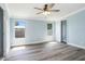 Light and airy bedroom with two windows letting in plenty of natural light and light wood-look flooring at 3924 Kiah Dr, Wesley Chapel, FL 33543