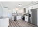 Bright kitchen with white cabinets, stainless steel appliances, granite counters and tile backsplash at 3924 Kiah Dr, Wesley Chapel, FL 33543