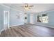 Open-concept living area with a ceiling fan, gray floors, and a pass-through to the adjacent kitchen at 3924 Kiah Dr, Wesley Chapel, FL 33543