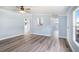 Spacious living area features recessed lighting, gray floors, and seamless transitions to other areas of the home at 3924 Kiah Dr, Wesley Chapel, FL 33543