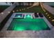 Aerial view of a well-lit swimming pool and jacuzzi with lounge chairs and lush landscaping at 4115 N Blvd, Tampa, FL 33603