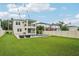 A spacious backyard with a modern pool, jacuzzi, lounge chairs, string lights and a large grassy area at 4115 N Blvd, Tampa, FL 33603