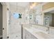 Modern bathroom with dual sinks, quartz countertops, and glass-enclosed shower at 4115 N Blvd, Tampa, FL 33603