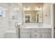 Bright bathroom with dual vanity, white cabinets, and a glass-enclosed shower at 4115 N Blvd, Tampa, FL 33603