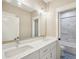 Bathroom features double sinks, large mirror, modern light fixtures, and a tile shower at 4115 N Blvd, Tampa, FL 33603