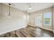 Well-lit bedroom features wood-look floors, a ceiling fan, and a door to a balcony at 4115 N Blvd, Tampa, FL 33603