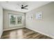 Inviting bedroom featuring wood-look flooring, ceiling fan, and multiple windows at 4115 N Blvd, Tampa, FL 33603