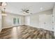 Bright bedroom featuring wood-look flooring, ceiling fan, and double doors to a balcony at 4115 N Blvd, Tampa, FL 33603