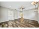 Bright bedroom showcasing wood-look floors with an open doorway to an attached bathroom at 4115 N Blvd, Tampa, FL 33603