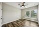 Well-lit bedroom featuring wood-look floors, a ceiling fan, and large windows at 4115 N Blvd, Tampa, FL 33603