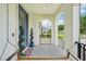 Inviting front porch featuring decorative tiling, an accent tree, and a relaxing porch swing at 4115 N Blvd, Tampa, FL 33603