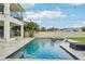 A backyard pool with a jacuzzi, lounge chairs, and stone tilework is perfect for relaxation and entertainment at 4115 N Blvd, Tampa, FL 33603