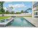 Enjoy outdoor living with a pool, a jacuzzi, and comfortable lounge chairs amidst a lush green lawn at 4115 N Blvd, Tampa, FL 33603