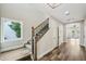 Elegant staircase featuring wooden steps, iron railings, and natural light from a large window at 4115 N Blvd, Tampa, FL 33603