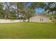Large, fenced backyard with well-maintained lawn and an exterior view of the home at 4121 W San Nicholas St, Tampa, FL 33629