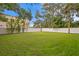 Expansive backyard featuring lush green grass and a secure white privacy fence at 4121 W San Nicholas St, Tampa, FL 33629