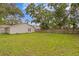 Spacious backyard with lush green grass and a wooden fence, great for outdoor activities at 4121 W San Nicholas St, Tampa, FL 33629