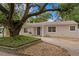 Inviting single story home featuring mature landscaping and a blue front door at 4121 W San Nicholas St, Tampa, FL 33629
