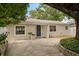 Charming single story home featuring a blue front door and mature landscaping at 4121 W San Nicholas St, Tampa, FL 33629