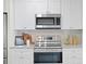 Close up shot of the kitchen appliances, including a stainless steel range and microwave and white tile backsplash at 4121 W San Nicholas St, Tampa, FL 33629