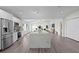 Open concept kitchen and living space featuring a large island, stainless steel appliances, and modern finishes at 4121 W San Nicholas St, Tampa, FL 33629