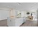 Open kitchen and dining area with a large kitchen island, stainless steel appliances, and modern finishes at 4121 W San Nicholas St, Tampa, FL 33629