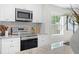 Close up shot of the kitchen appliances, including a stainless steel range and microwave and white tile backsplash at 4121 W San Nicholas St, Tampa, FL 33629
