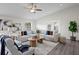 Bright living room with vaulted ceiling, modern ceiling fan, comfortable seating, and natural light at 4121 W San Nicholas St, Tampa, FL 33629