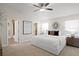 Bright main bedroom with a ceiling fan, carpet and ensuite bathroom and walk-in closet at 4121 W San Nicholas St, Tampa, FL 33629
