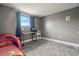 Bedroom features a play area, a window with natural light, gray walls and wood floors at 4150 Pecos Dr, New Port Richey, FL 34653