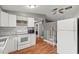Modern kitchen with white cabinets, stainless steel appliances, and hardwood floors at 4150 Pecos Dr, New Port Richey, FL 34653