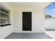 Small back porch with a solid back door entrance to the home at 4461 Shore Acres Ne Blvd, St Petersburg, FL 33703