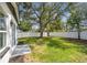 Spacious backyard features a privacy fence, large tree, and green grass at 4461 Shore Acres Ne Blvd, St Petersburg, FL 33703