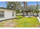Well-maintained backyard with a wooden pergola, palm tree, and white vinyl fence at 4461 Shore Acres Ne Blvd, St Petersburg, FL 33703