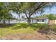 Extensive backyard with pergola, shade tree, white vinyl fence, and lush green grass at 4461 Shore Acres Ne Blvd, St Petersburg, FL 33703
