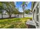 Beautiful backyard with a pergola, lush green grass, and a white vinyl fence at 4461 Shore Acres Ne Blvd, St Petersburg, FL 33703
