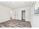 Bright bedroom with gray wood floors, storage closet and access to bathroom at 4461 Shore Acres Ne Blvd, St Petersburg, FL 33703