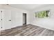 Bedroom featuring storage closet, wood-look flooring and a single window at 4461 Shore Acres Ne Blvd, St Petersburg, FL 33703