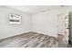 Bedroom featuring a single window and gray wood floors at 4461 Shore Acres Ne Blvd, St Petersburg, FL 33703