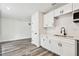 Bright kitchen with white cabinets, modern black fixtures, and stainless steel appliances at 4461 Shore Acres Ne Blvd, St Petersburg, FL 33703