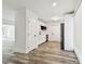 Modern kitchen with white cabinets, stainless steel appliances, and wood-look flooring at 4461 Shore Acres Ne Blvd, St Petersburg, FL 33703