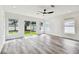 Spacious living room with backyard access and ceiling fan at 4461 Shore Acres Ne Blvd, St Petersburg, FL 33703